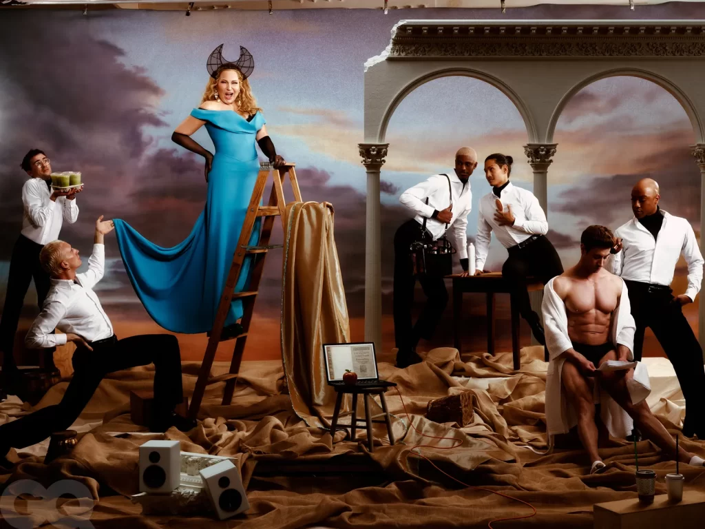 A woman in a blue dress stands on a ladder holding a long train, accompanied by men engaged in various activities, against a backdrop with columns and clouds.